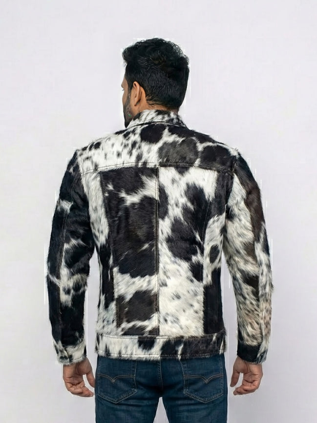 Person wearing a black and white cowhide leather jacket on a white background