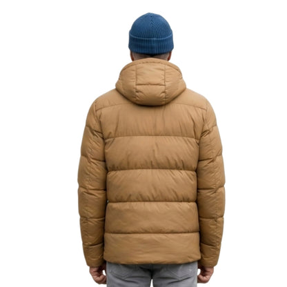 Person wearing a brown puffer jacket and blue beanie on a white background