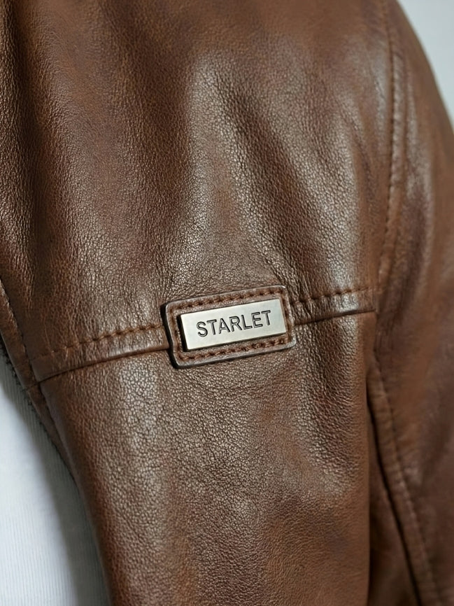 Brown leather jacket with 'STARLET' label on a light gray background