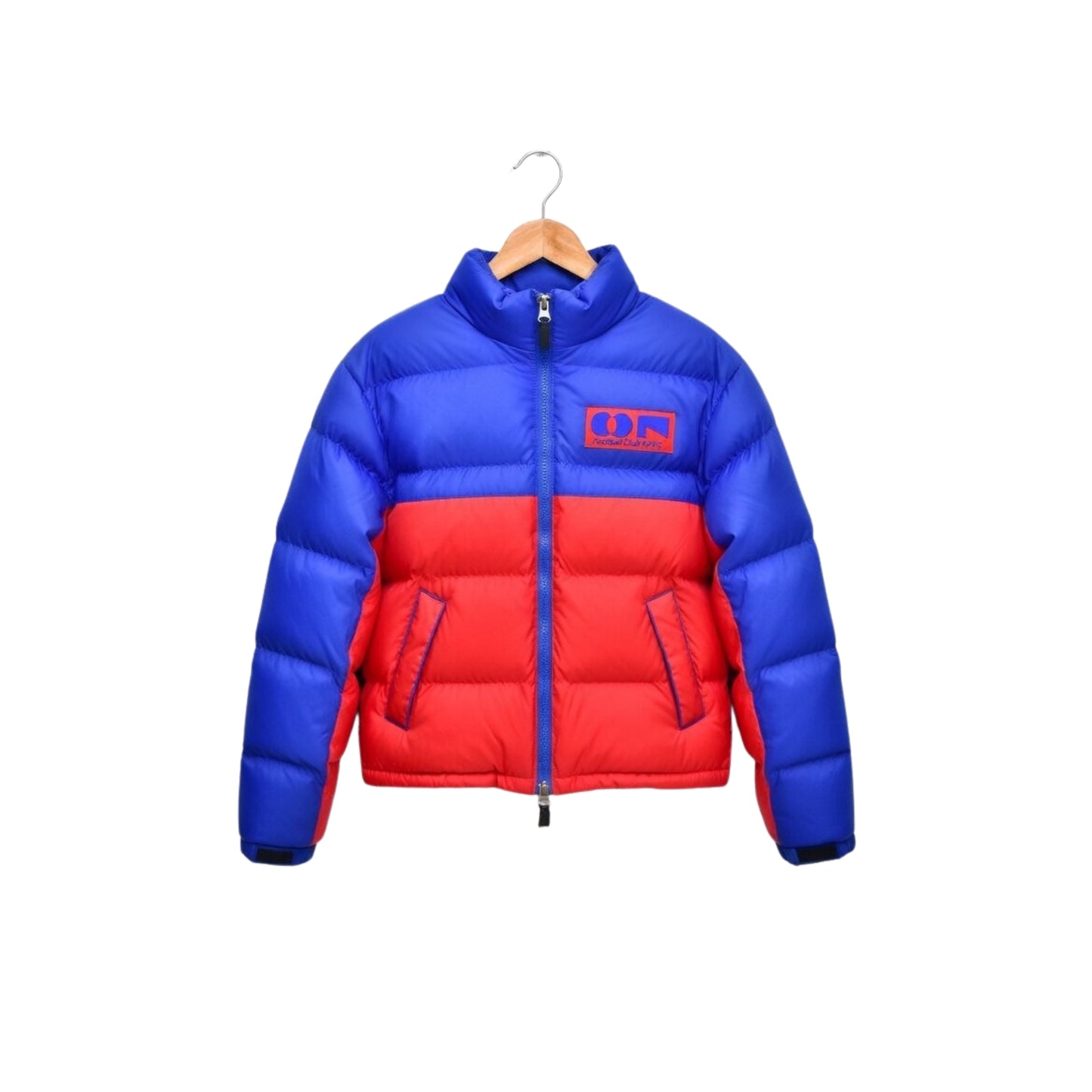 Blue and red puffer jacket on a hanger against a white background