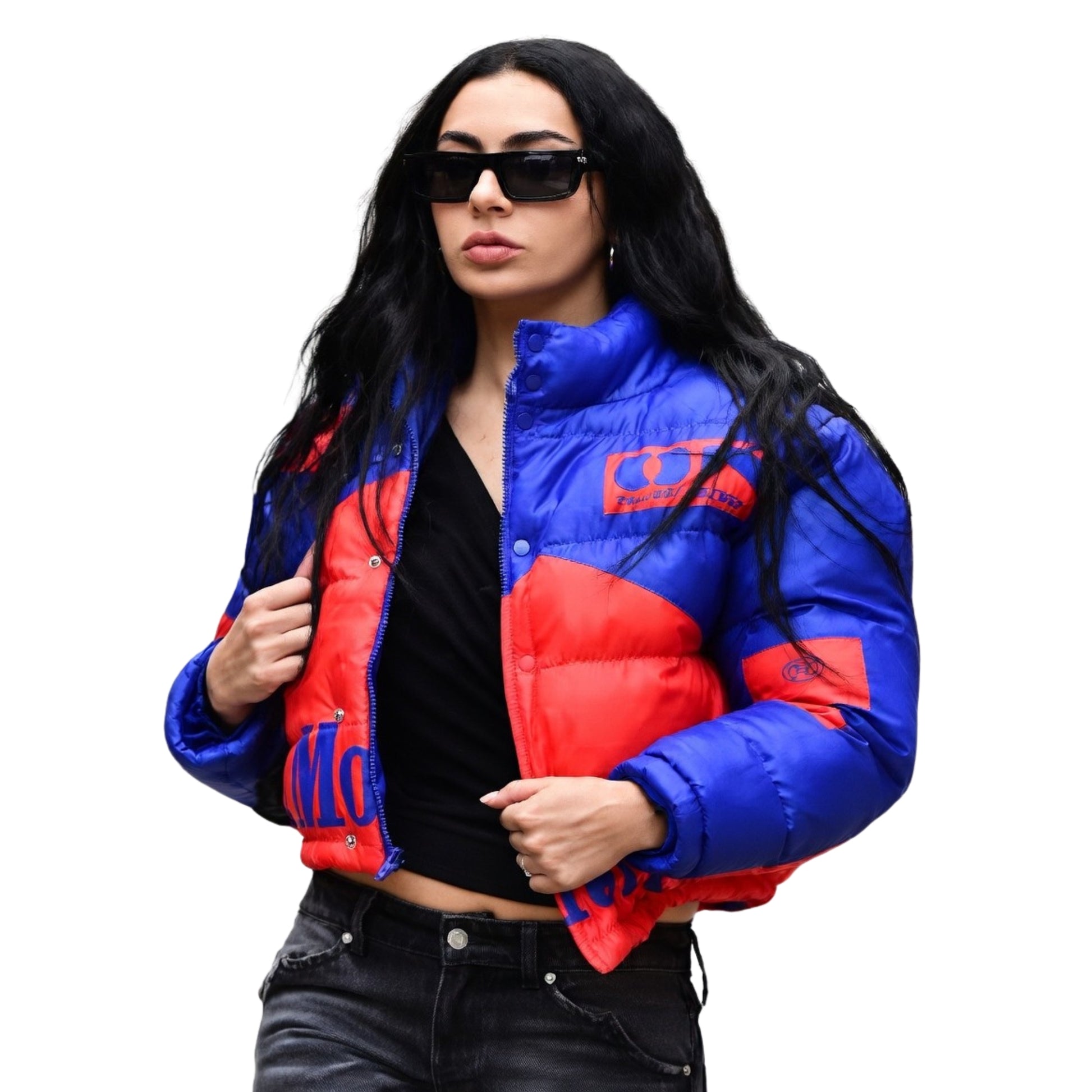 Woman wearing a blue and red puffer jacket on a white background