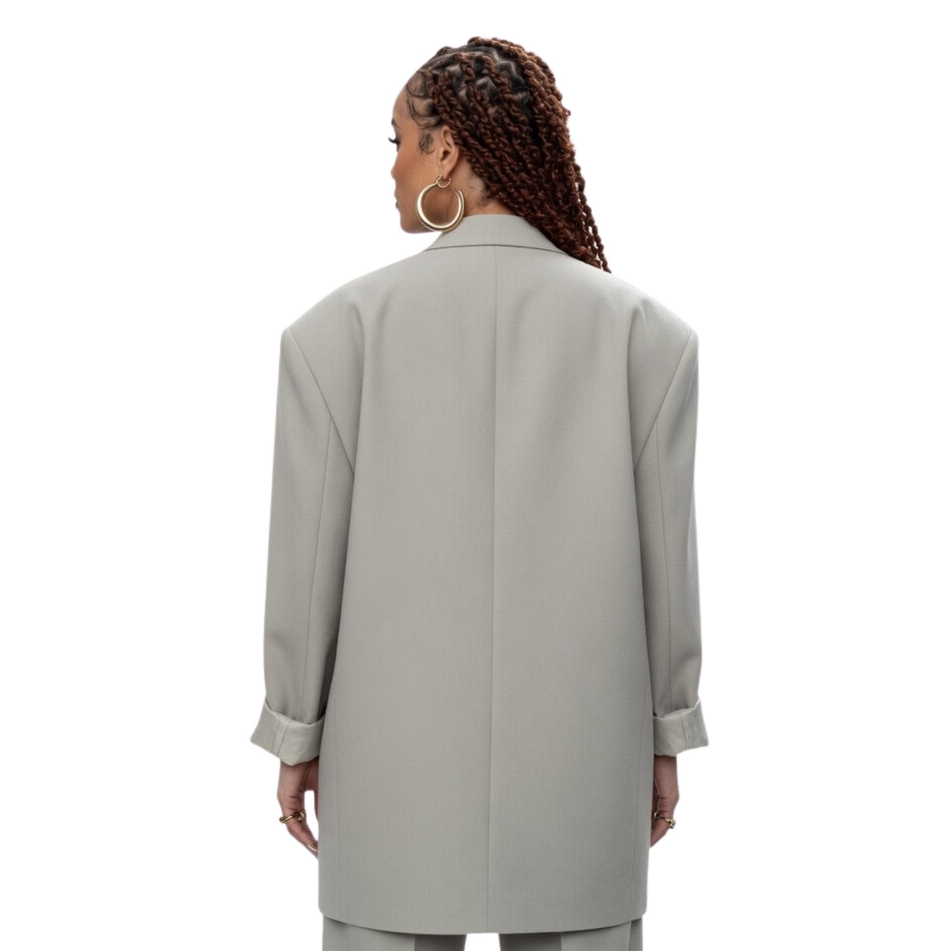 Person wearing a light gray coat on a white background
