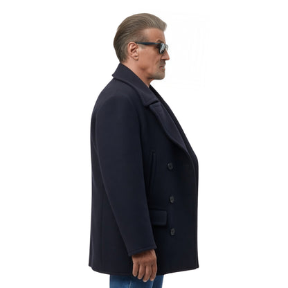Man wearing a dark coat and sunglasses on a white background