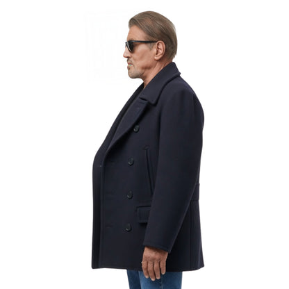 Man wearing a dark coat and sunglasses on a white background