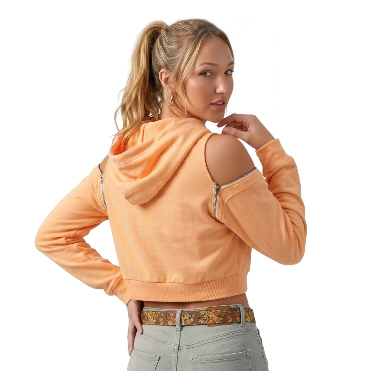 Woman wearing an orange hoodie with cut-out shoulders on a white background