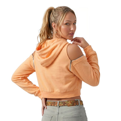 Woman wearing an orange hoodie with cut-out shoulders on a white background