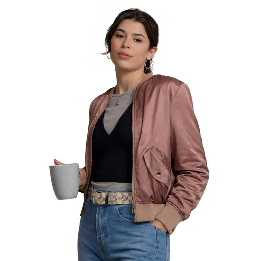 Woman holding a white mug wearing a pink jacket and blue jeans on a white background