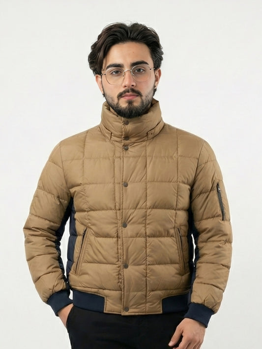 Man wearing a beige puffer jacket on a white background