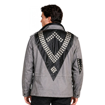 Man wearing a gray jacket with black geometric patterns on the back against a white background