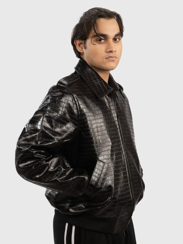 Man wearing a black crocodile-patterned jacket on a white background