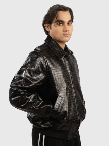 Man wearing a black crocodile-patterned jacket on a white background