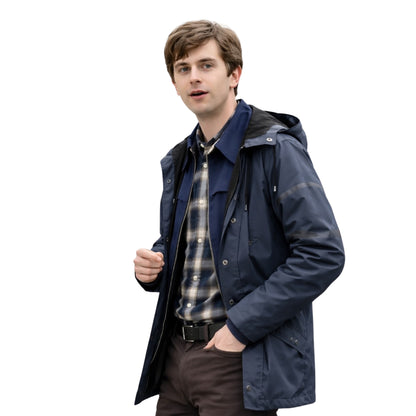Man wearing a navy raincoat over a plaid shirt on a white background