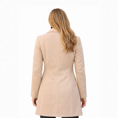 Woman wearing a beige coat on a white background