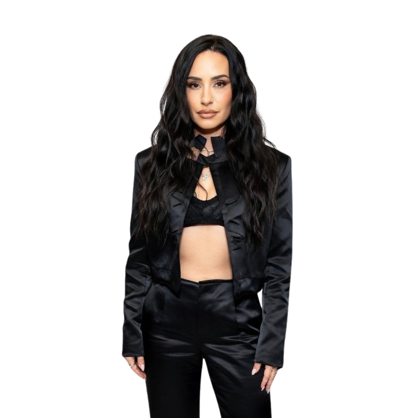 Woman wearing a black outfit with ruffled details on a white background