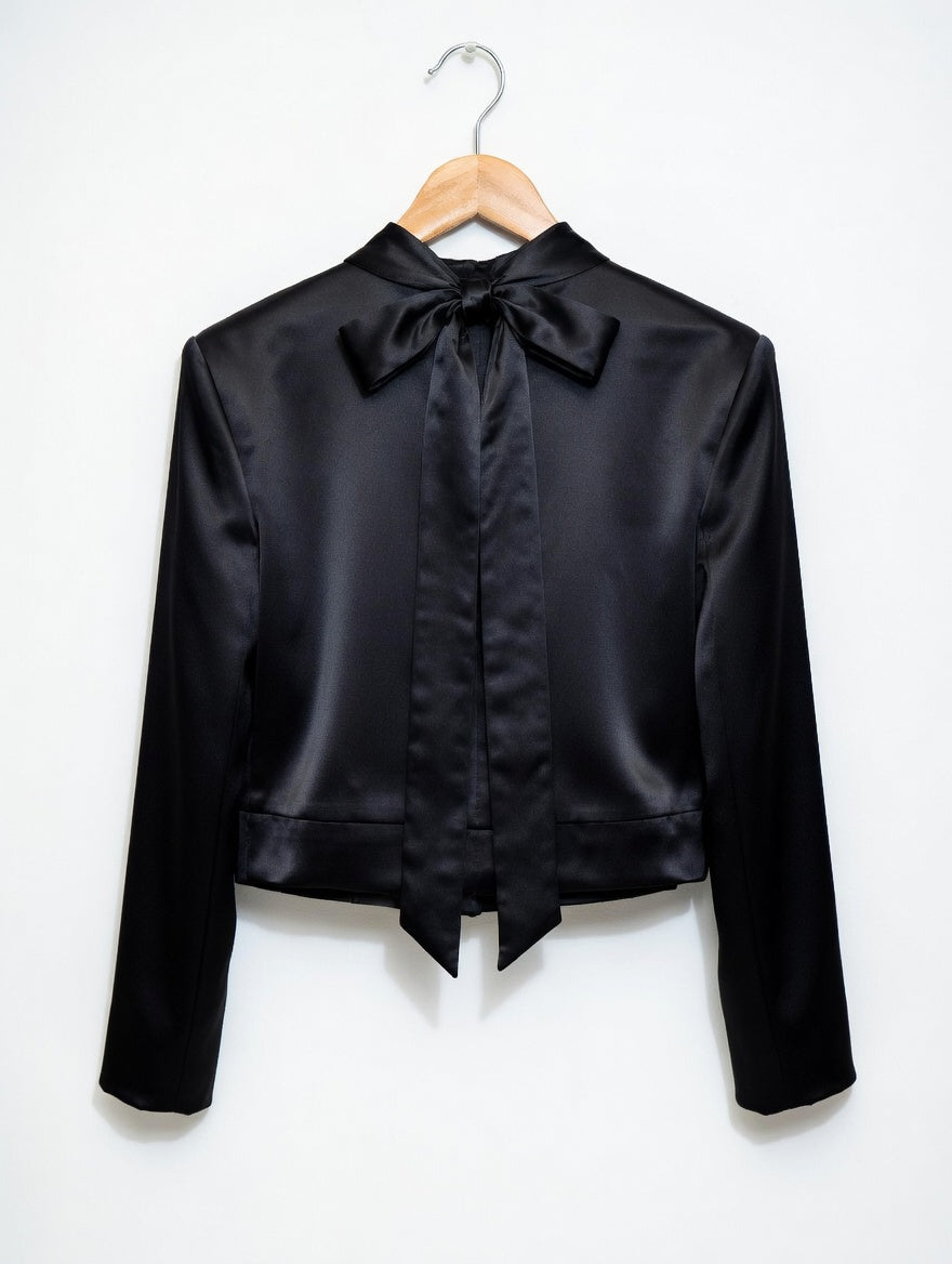 Black satin jacket with a bow on a white background