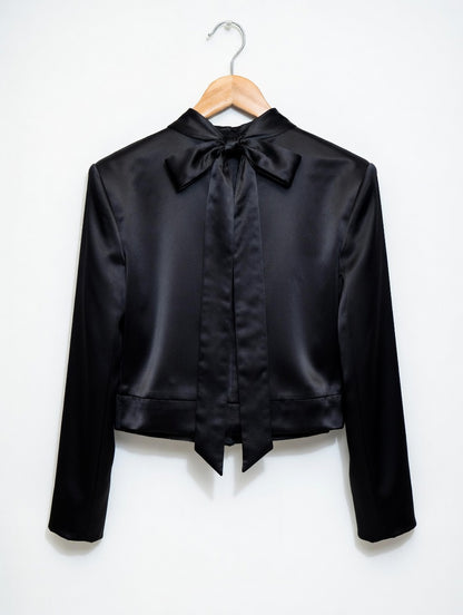 Black satin jacket with a bow on a white background
