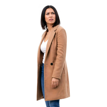 Woman wearing a tan coat on a white background