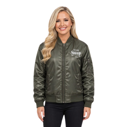 Woman wearing a green bomber jacket with 'Team Snoop' text on a white background