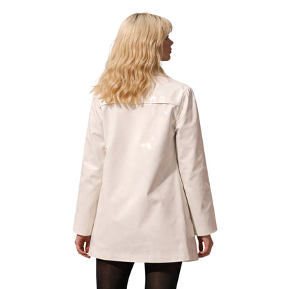 Woman wearing a beige coat on a white background