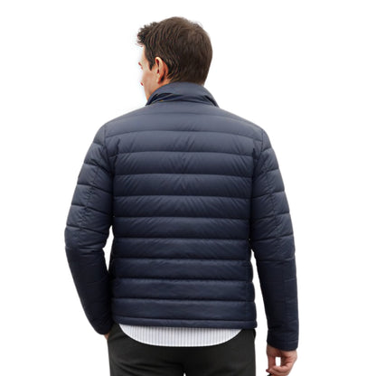 Man wearing a navy blue puffer jacket on a white background