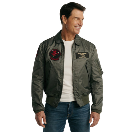 Man wearing a green flight jacket with patches on a white background
