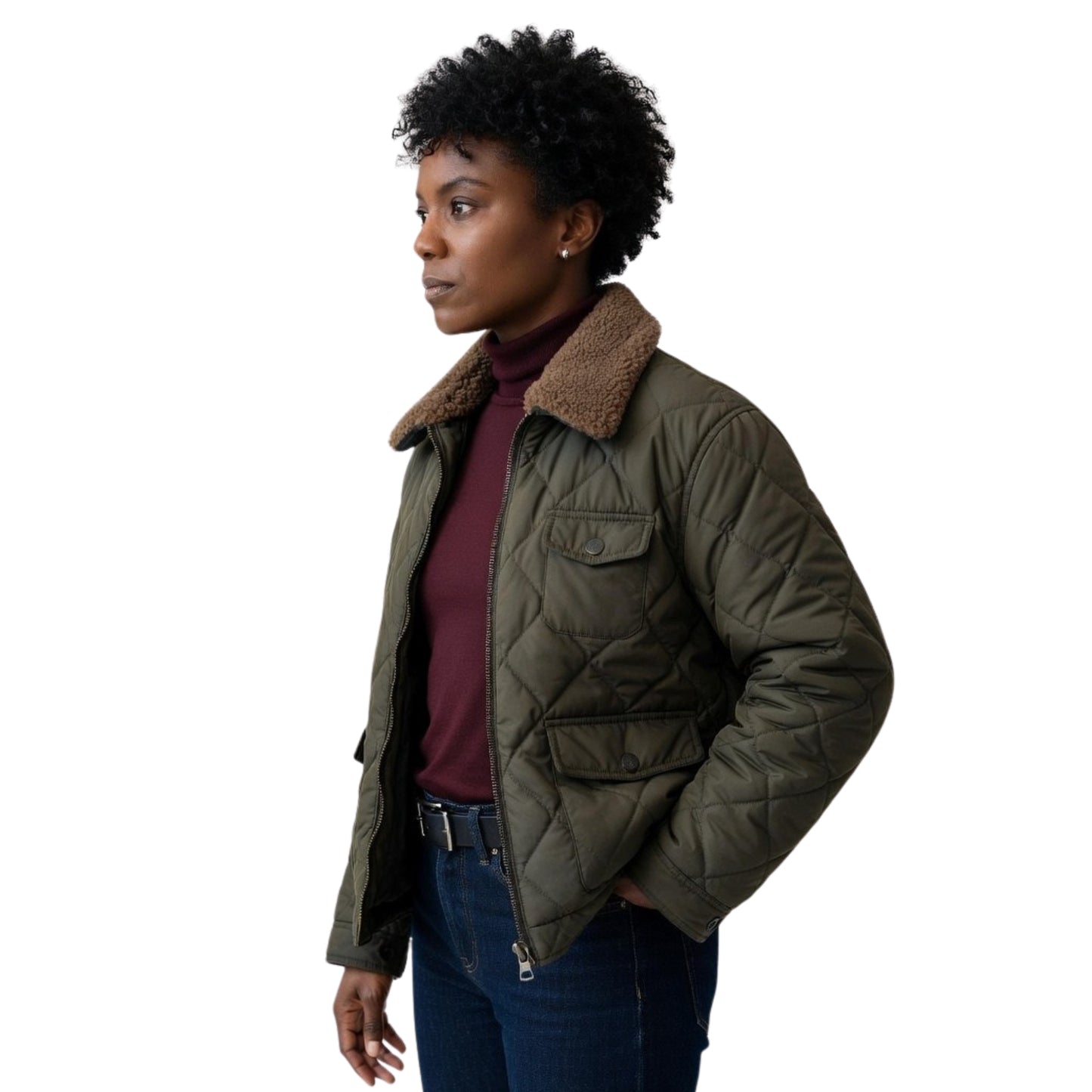 Woman wearing a green quilted jacket with a fur-lined hood on a white background
