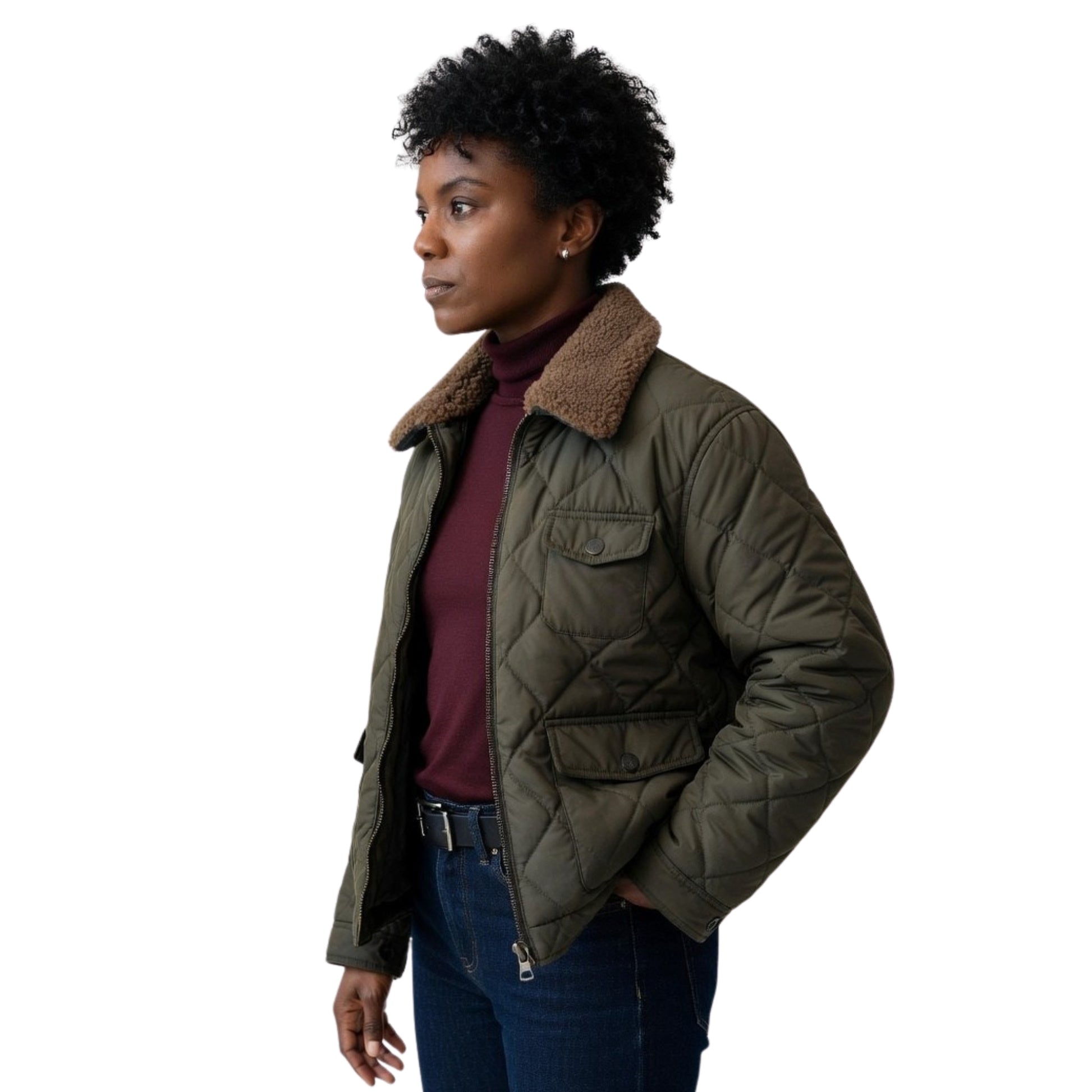 Woman wearing a green quilted jacket with a fur-lined hood on a white background