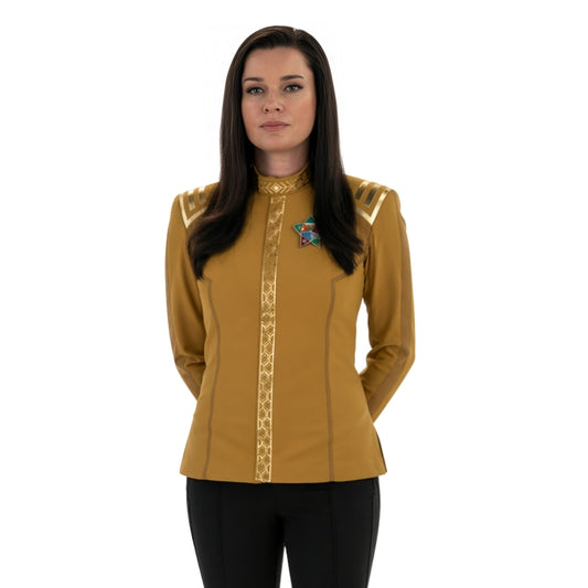 Woman wearing a yellow long-sleeve shirt with decorative elements on a white background