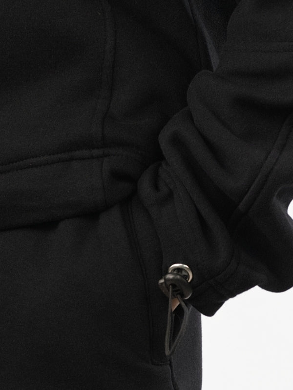 Close-up of a black coat with a button on a white background