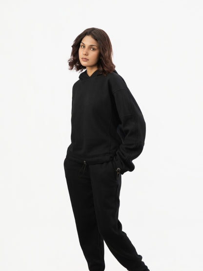 Person wearing a black outfit on a white background
