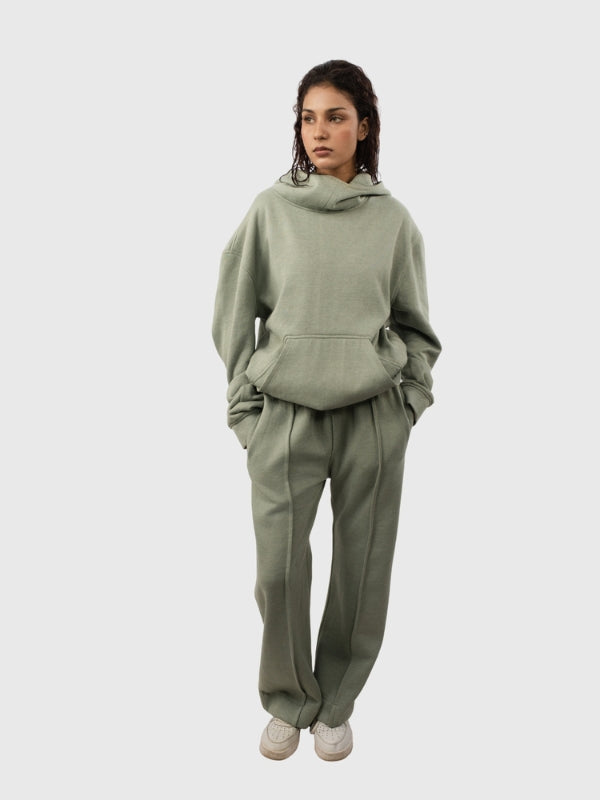 Person wearing a green tracksuit on a white background