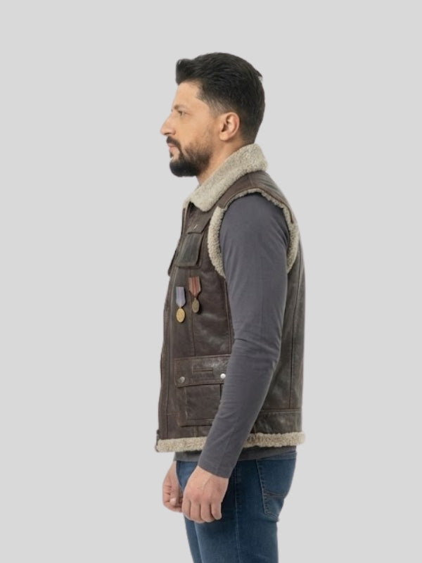 Man wearing a brown leather vest with fur trim on a light gray background