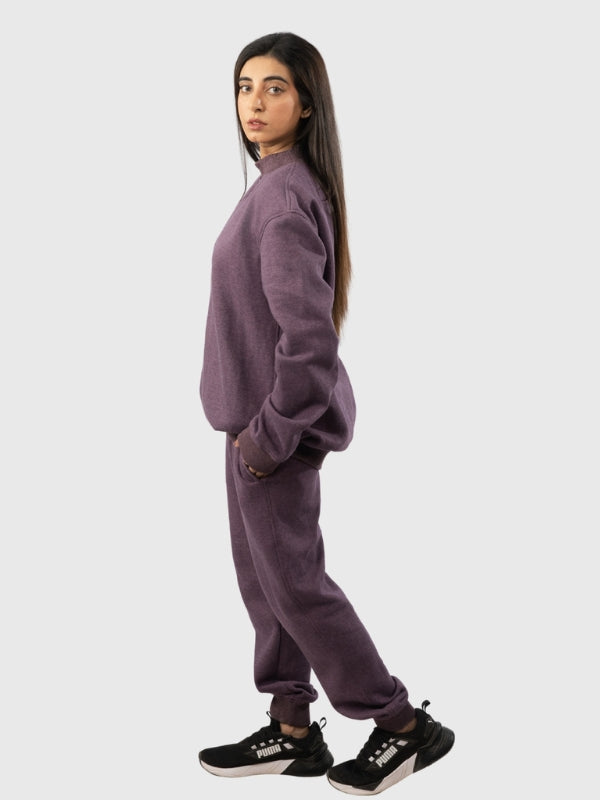 Person wearing a purple tracksuit on a white background