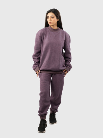 Person wearing a purple sweatshirt and pants set on a white background