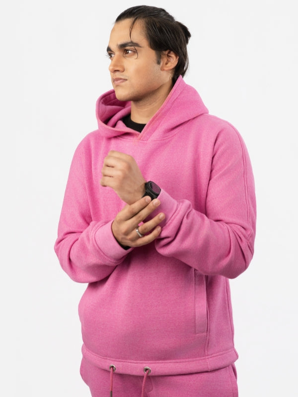 Person wearing a pink hoodie on a white background