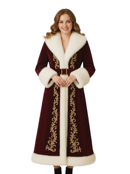 Woman wearing a long, ornate coat with white fur trim on a white background