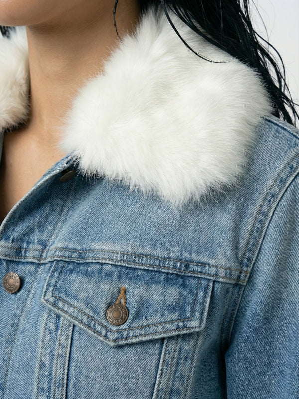 Close-up of a denim jacket with a white fur collar