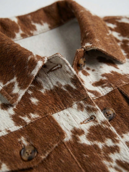 Close-up of a brown and white cowhide jacket with buttons.