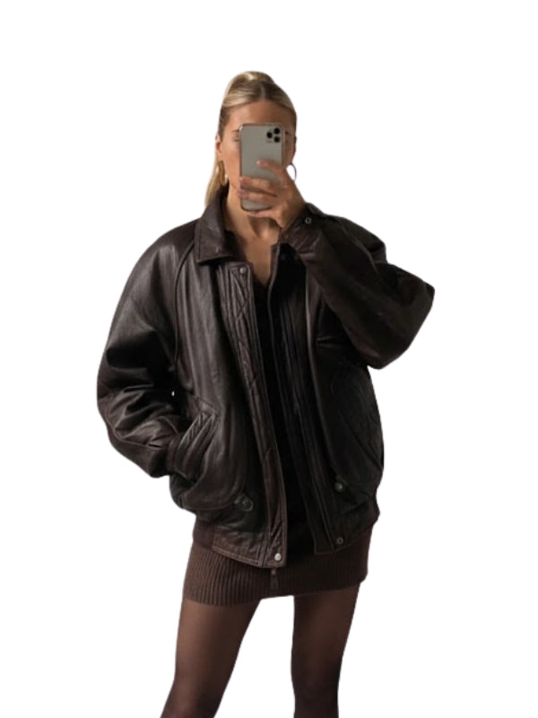 Person wearing a brown leather jacket on a white background