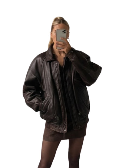 Person wearing a brown leather jacket on a white background