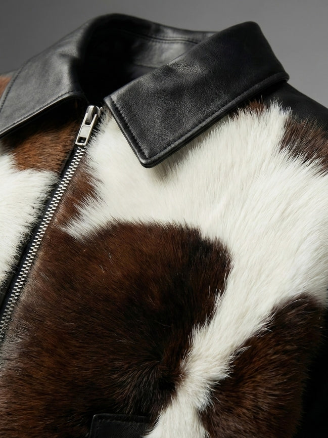 Close-up of a brown and white fur jacket with a black leather collar.