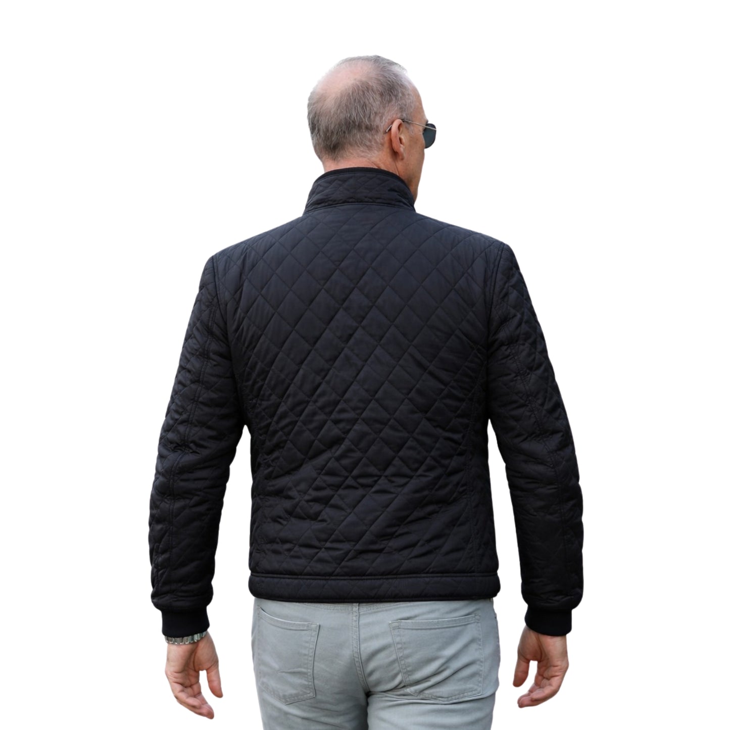 Man wearing a black quilted jacket on a white background