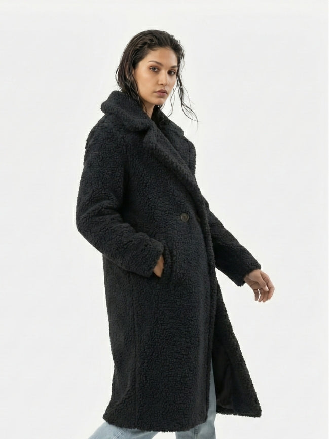 Woman wearing a black coat on a white background