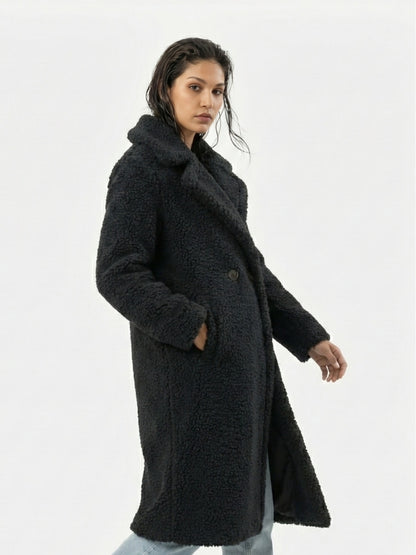 Woman wearing a black coat on a white background