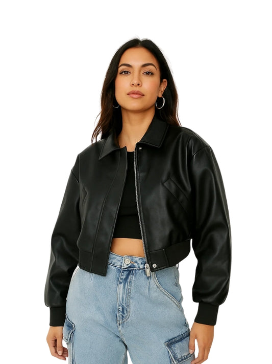 Woman wearing a black leather jacket and blue jeans on a white background