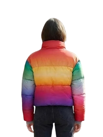 Person wearing a rainbow-colored puffer jacket on a white background
