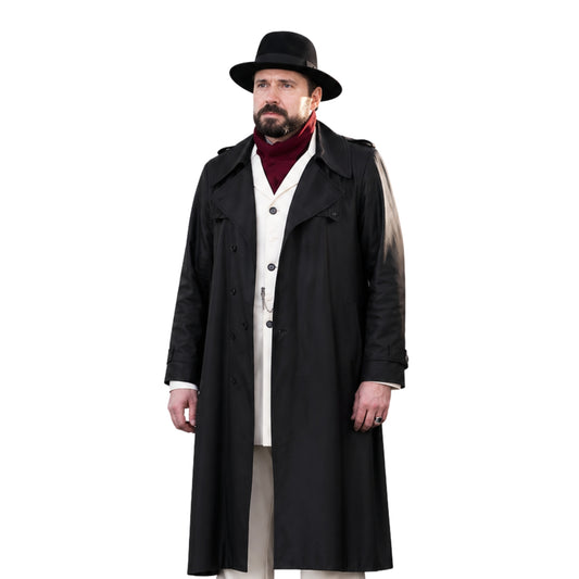 Man wearing a long black coat, hat, and red sweater on a white background