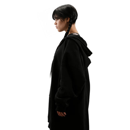 Person wearing a black hooded outfit on a white background
