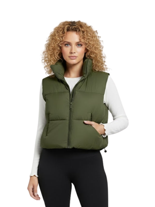 Woman wearing a green puffer vest on a white background