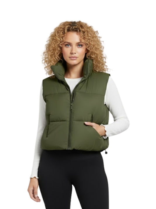 Woman wearing a green puffer vest on a white background